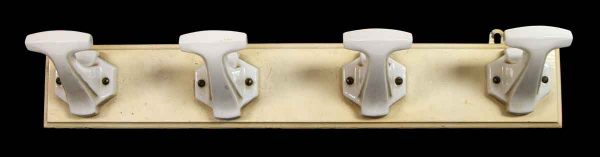 Four Ceramic Hooks on Wood Plank
