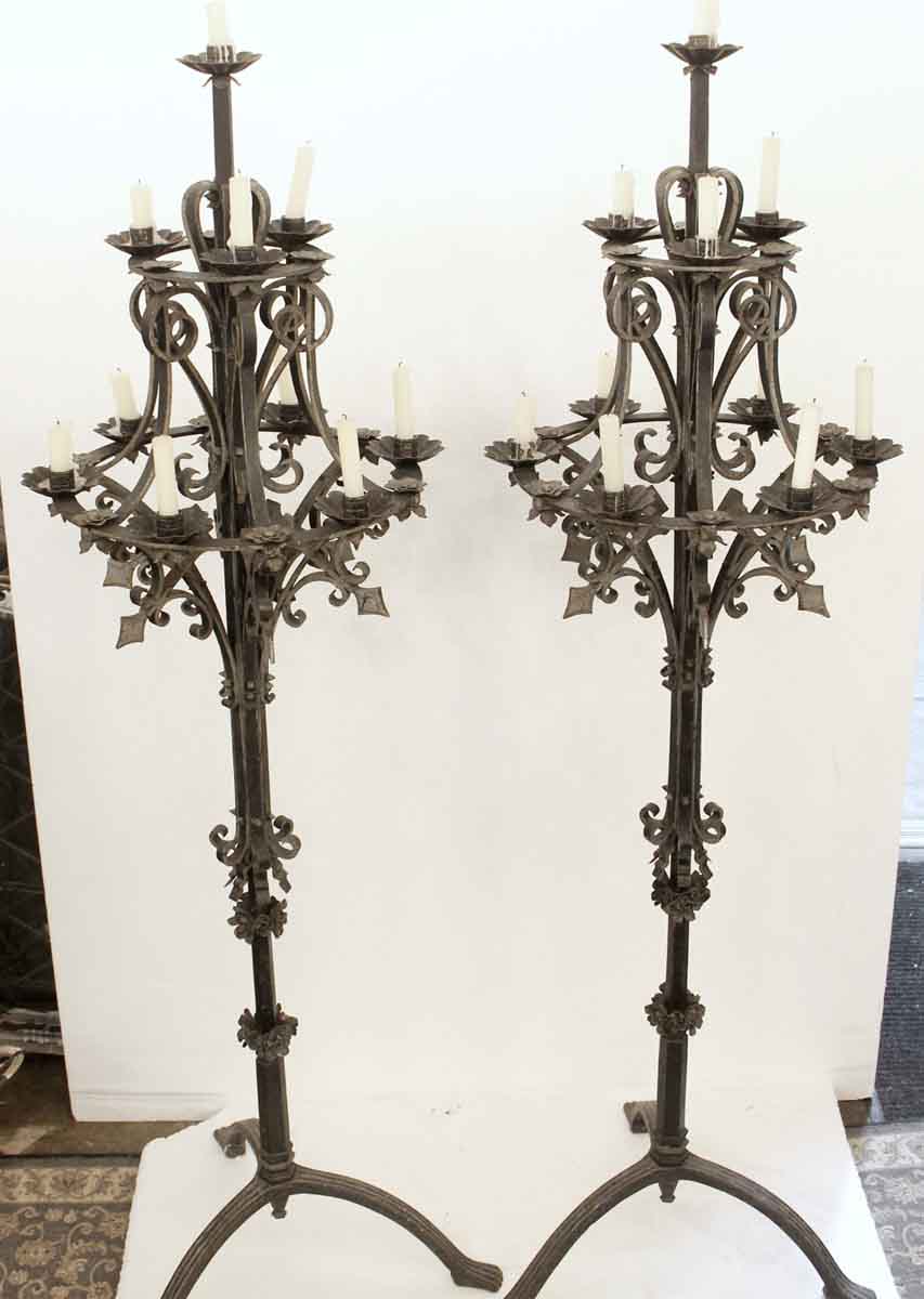 A pair of wrought iron Gothic candlesticks